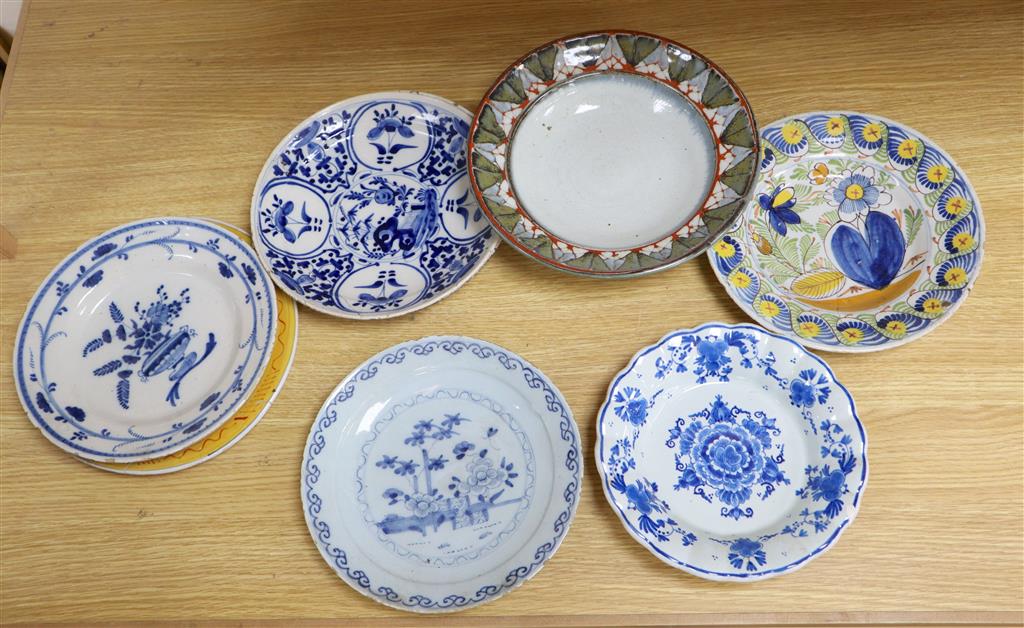 Seven various 18th century and later delft ware dishes, largest 24cm, some damage and a Studio pottery dish, 25cm